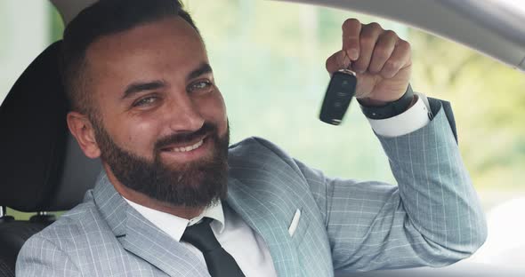 Confident Businessman Smiling To Camera and Showing Key of His New Car, Close Up