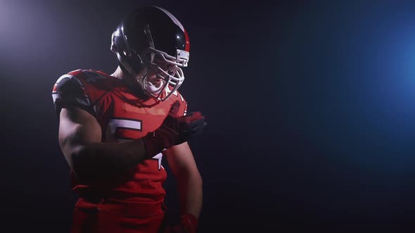 Portrait of Determined Professional American Football Player in Helmet Standing Isolated