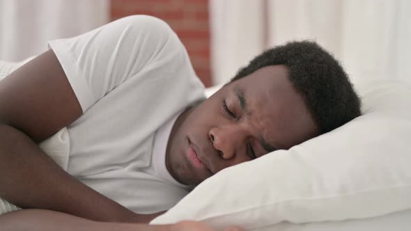 African Man Sleeping in Bed 
