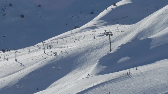 Slow motion of the ski resort Pas de la Casa, with skiers and lifts