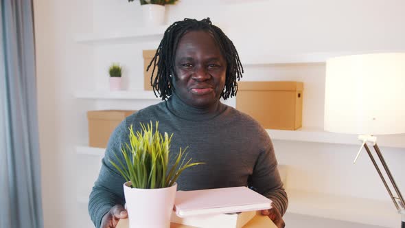 Happy Young Black Man Moving in the New House