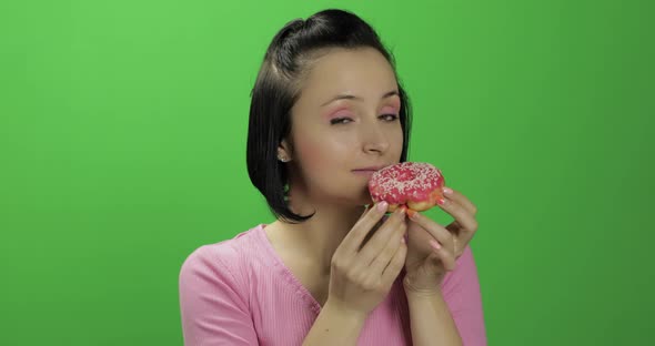 Happy Beautiful Young Girl Posing and Wants To Eat a Donut. Chroma Key