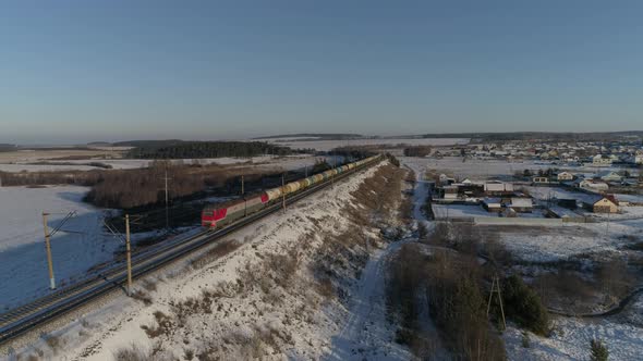 freight train travels by rail from far away and approaches the camera 11