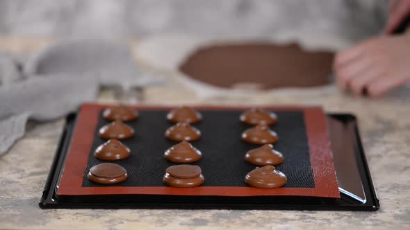 Pastry Chef Decorates Raw Profiteroles with Chocolate Shortcrust Pastry.