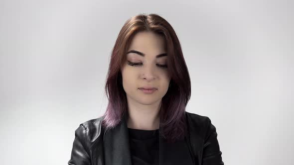 Portrait of Young Sad Woman Who Is About To Cry on the White Background