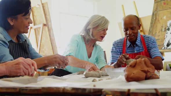 Artist molding a clay at table 4k