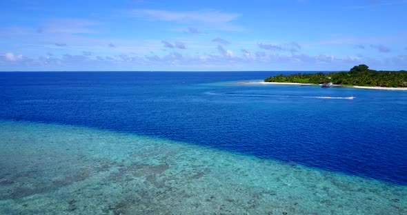 Wide angle drone island view of a sandy white paradise beach and aqua turquoise water background