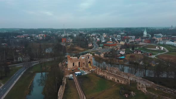 Medieval Castle the Town of Dobele on the West Bank of the River Berze in Winter. Aerial 4K Video