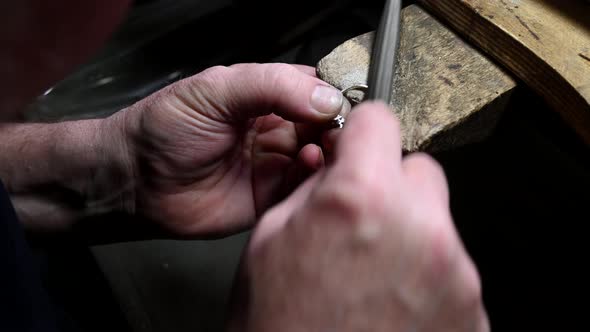 Closeup of Wedding Ring Polishing By Caicasian Jeweler Isolated  Footage