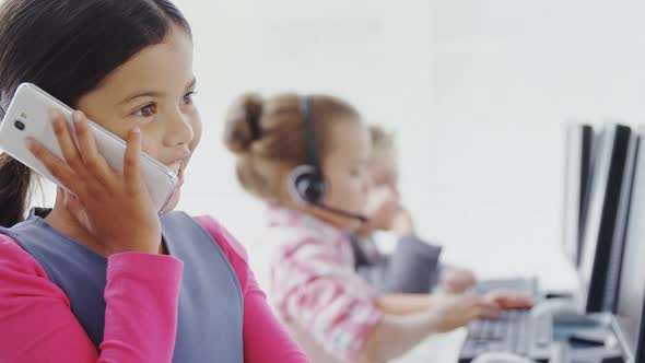 Girl as executive talking on the mobile phone in call center