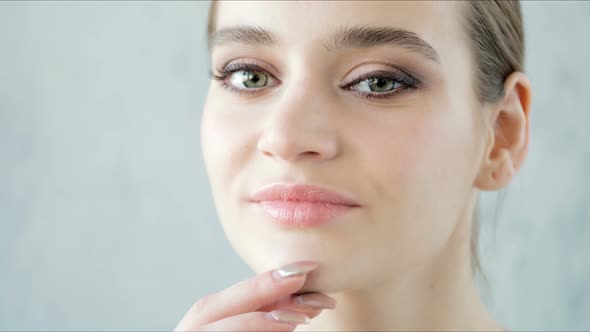 Pretty Girl with Clean Skin Big Eyes and Dark Eyebrows Looking at Camera Closeup Concept