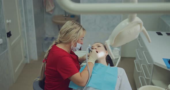 Dentist Doctor Cleans the Channels in the Tooth