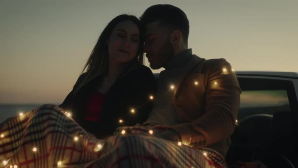 Engaged couple In Love At Sunset on a Car