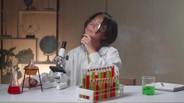 Young Scientist Girl With Dirty Face Looking At Microscope And Thinking In Laboratory