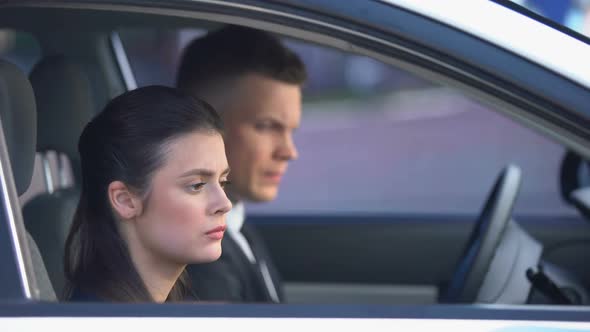 Unhappy Husband and Wife Sitting in Car After Fight