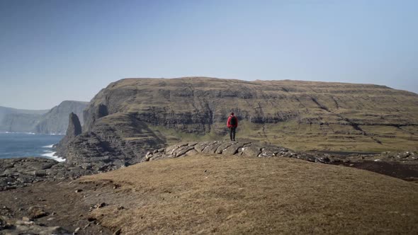 Hiker Looking At Sea And Dramatic Landscape