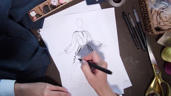 Hands of Clothes Designer Drawing Sketch of Dress