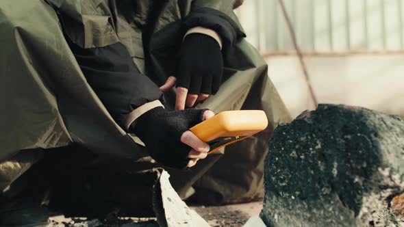 Man with Geiger Counter Near Radioactive Barrels