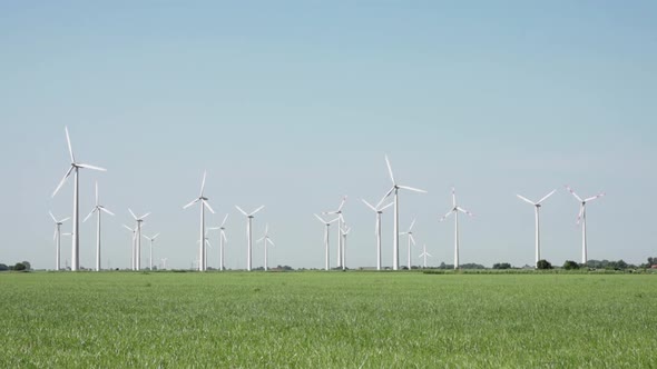 View to electric windmill and gray sky in a sunny day