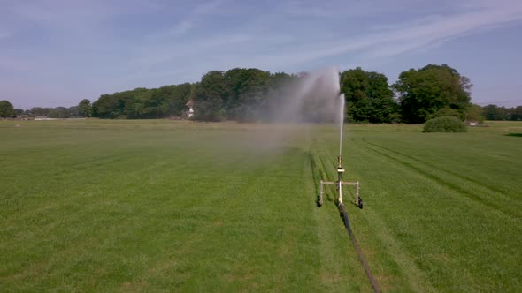 Watering an agricultural field with water sprinkler in area the Achterhoek in the Netherlands