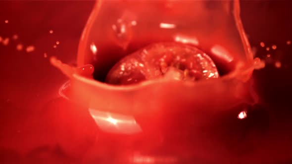 Super Slow Motion Round a Piece of Tomato Falls Into the Tomato Juice