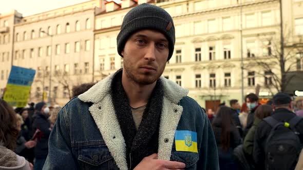 Protester showing Ukraine flag on his chest at a demonstration, Prague.