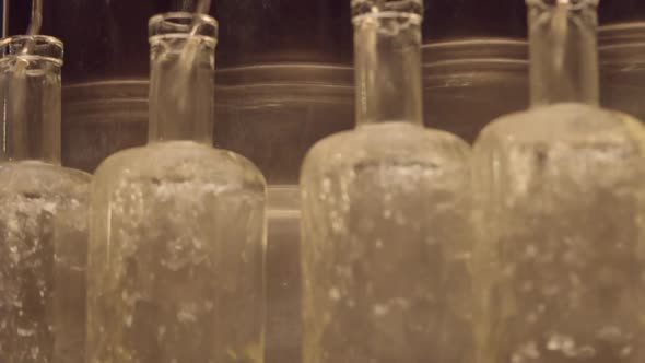 Whiskey pouring into bottles ready for labels