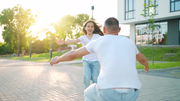 Daughter Runs to Dad and Hugs Him