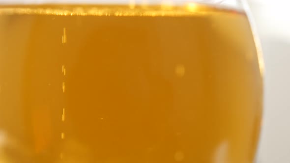 Glass of beer filled with fresh baverage 4K 3840X2160 UltraHD video - Bubbles in glass of beer slowl