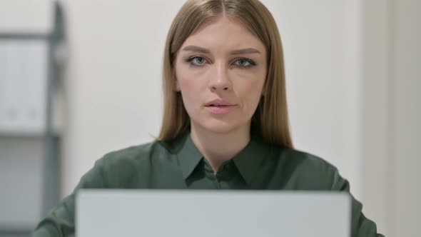 Thumbs Down By Woman Using Laptop