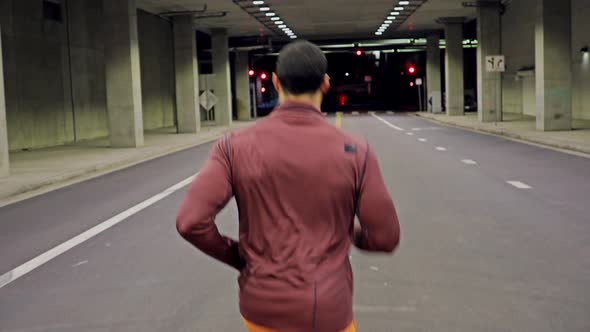 Athletic Male Running Through A Tunnel