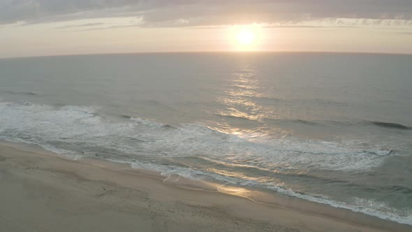 Aerial view of gentle waves rolling in from the surf