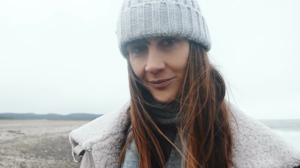 Close-up Portrait of Beautiful Happy Female Tourist Smiling at Camera, Posing at Cold Windy Winter