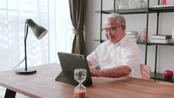 Middle-aged male using portable technology. Digital inclusion and accessibility concept.