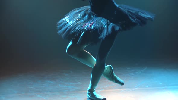 Graceful Legs of a Ballerina in White Pointe Shoes. Ballerina Shows Classic Ballet Pas. Shot in a