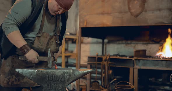 Blacksmith Brushes the Iron Product and Puts It in the Furnace