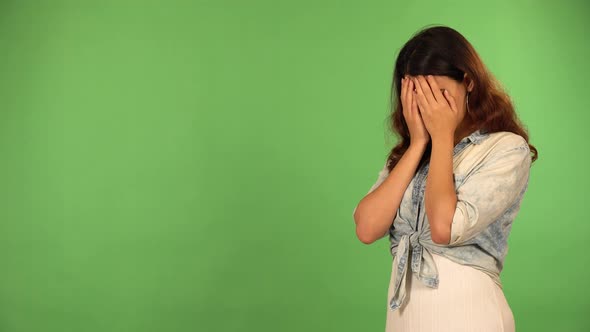 A Young Caucasian Woman Covers Her Eyes Uncovers Them and Looks Around in Awe  Green Screen