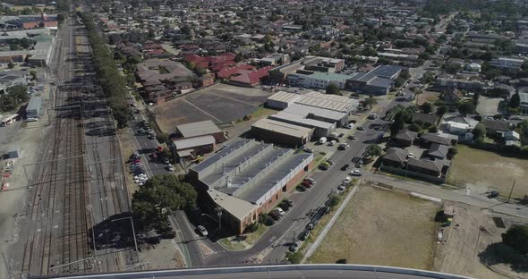 Static perspective of aerial view looking up v shaped intersection meeting at a round about below.