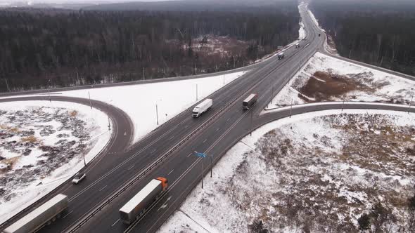 Long Suburban Highway with a Roundabout in Winter Aerial View