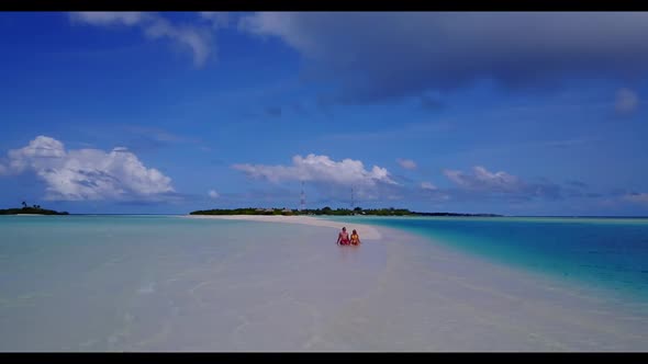 Man and woman happy together on relaxing bay beach journey by blue water and white sandy background 