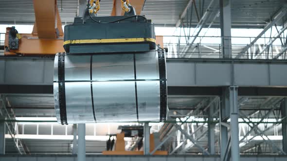 Loading Sheet Metal in a Warehouse Using a Crane and an Electromagnet