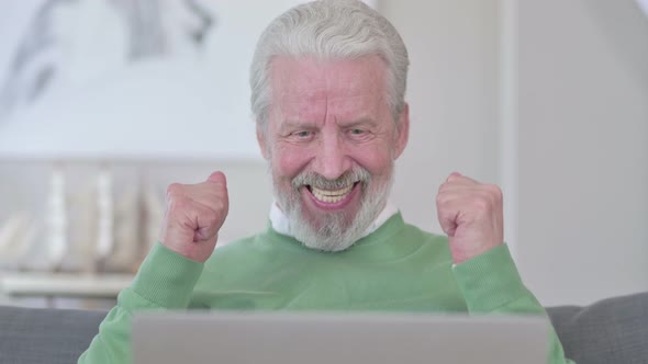 Close Up of Old Man Celebrating Success on Laptop