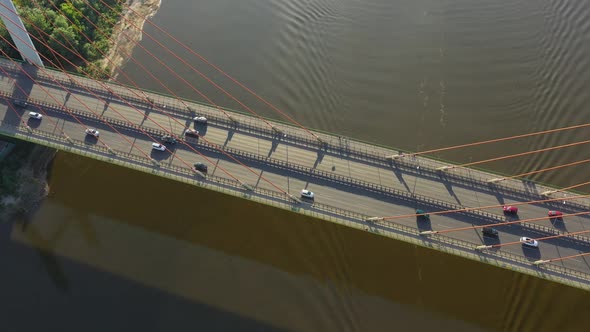 Beautiful top-down shot of traffic on modern cable stayed bridge. Rambler channel bright blue-green