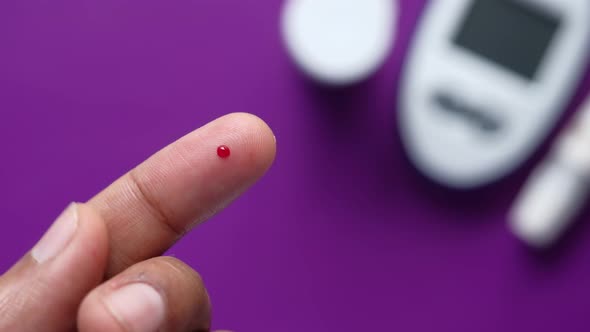 Young Man's Hand Measure Glucose Level at Home 