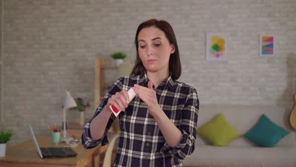 Young Woman Puts Cream on a Scar From a Burn on Her Face