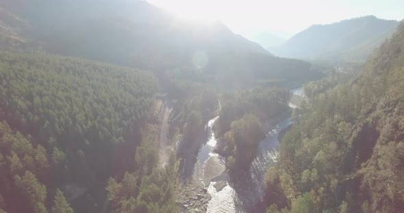 Low Altitude Flight Over Fresh Fast Mountain River with Rocks at Sunny Summer Morning