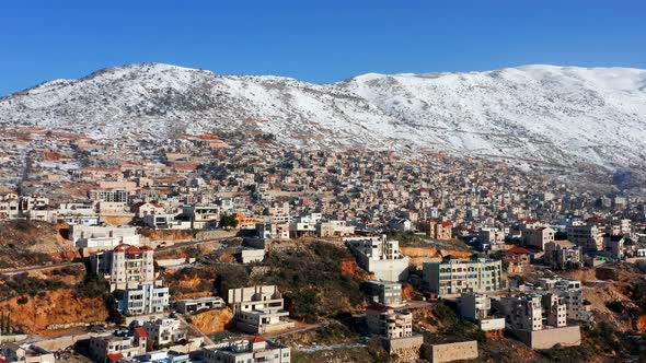 Hermon mountain ridge covered with snow during 2022 winter, with the town houses of Majd al Shams.