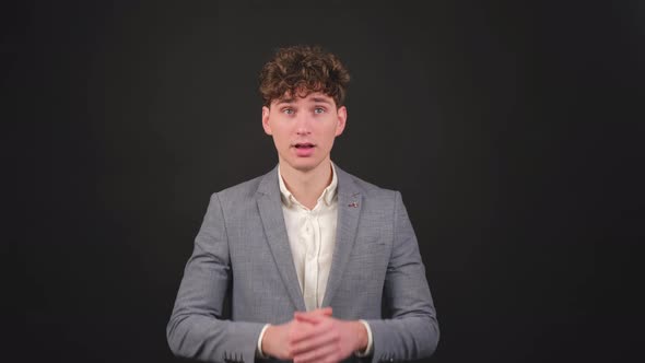 Young Man Showing Surprise and Amazed Expression with Hands on Face