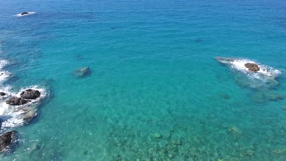 Aerial Clear Reef and Rocky Untouched Coastline of Bright Turquoise Sea