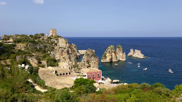 Spectacular panoramic view of Stacks or Faraglioni of Scopello and Torre Doria tower in Sicily. Ital